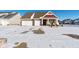 Exterior view of home with three-car garage and snow-covered driveway at 3629 S Meadows Ln, New Palestine, IN 46163