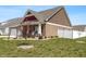 Charming brick home with a well-manicured lawn, white fence, and inviting front porch at 3629 S Meadows Ln, New Palestine, IN 46163