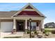 Inviting front porch with classic columns, a dark entryway door and seating area at 3629 S Meadows Ln, New Palestine, IN 46163