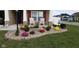 Landscaped front yard with flowers and chairs on porch at 3629 S Meadows Ln, New Palestine, IN 46163