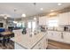 Bright kitchen featuring an island with granite countertops, white cabinets, and stainless steel appliances at 3629 S Meadows Ln, New Palestine, IN 46163