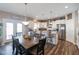 Spacious kitchen with stainless appliances, dining table, and ample counter space, perfect for entertaining at 3629 S Meadows Ln, New Palestine, IN 46163