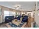 Open-concept living area with a fireplace, blue furniture, and seamless flow to the kitchen at 3629 S Meadows Ln, New Palestine, IN 46163