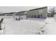 Winter backyard with a snow-covered lawn, patio seating, and a white fence at 387 Legacy Blvd, Greenwood, IN 46143
