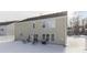 Snowy backyard features a patio area with seating and grill, perfect for enjoying outdoor living at 387 Legacy Blvd, Greenwood, IN 46143