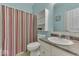 Cozy bathroom featuring a striped shower curtain and a white vanity with a granite-style countertop at 387 Legacy Blvd, Greenwood, IN 46143