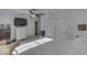 Bright bedroom featuring a ceiling fan, TV, and a view into the adjacent bathroom at 387 Legacy Blvd, Greenwood, IN 46143