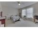 Bedroom with a ceiling fan, floral bedding, and a window for natural light at 387 Legacy Blvd, Greenwood, IN 46143