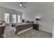Bright bedroom with a large window, ceiling fan, neutral carpet, and a comfortable queen-sized bed at 387 Legacy Blvd, Greenwood, IN 46143