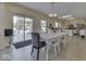 Bright dining area with a long table, sliding glass door to the backyard, and a view into the kitchen at 387 Legacy Blvd, Greenwood, IN 46143