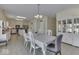 Open dining area connecting to a spacious kitchen with white cabinets and modern appliances at 387 Legacy Blvd, Greenwood, IN 46143