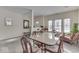 Dining room with large windows and ample lighting. Connected to living room with carpet flooring at 387 Legacy Blvd, Greenwood, IN 46143