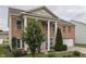 Two story home has a brick facade, a lawn and large columns at the entryway at 387 Legacy Blvd, Greenwood, IN 46143