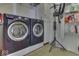 Laundry room featuring front load washer and dryer with storage cabinet and drying rack at 387 Legacy Blvd, Greenwood, IN 46143