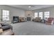 Spacious living room with carpet, fireplace, and large windows for natural light at 387 Legacy Blvd, Greenwood, IN 46143
