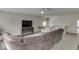 Relaxing living room with a large sofa, tv on drawers, ceiling fan, and lots of space at 387 Legacy Blvd, Greenwood, IN 46143