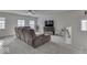 Inviting living room with plush seating, complemented by a large window and a ceiling fan at 387 Legacy Blvd, Greenwood, IN 46143