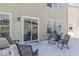 Close-up of a backyard patio featuring chairs, a table, and a grill, covered in snow at 387 Legacy Blvd, Greenwood, IN 46143