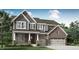 Charming two-story home with brick and gray siding, a covered porch, and a three-car garage at 5218 Pelion Pl, McCordsville, IN 46055