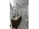 Bathroom with a double sink vanity, granite countertop, and tub-shower combination at 526 N Oxford St, Indianapolis, IN 46201