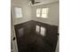 Bright bedroom featuring dark wood floors, ceiling fan, and natural light from windows at 526 N Oxford St, Indianapolis, IN 46201
