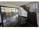 Open-concept living space featuring wood floors, fireplace, and an adjacent staircase at 526 N Oxford St, Indianapolis, IN 46201