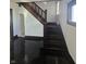 Classic wood staircase and dark floors in the home's entrance area at 526 N Oxford St, Indianapolis, IN 46201