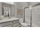 Bathroom with a shower, toilet, and vanity with sink, and a view into the kitchen at 5314 Pelion Pl, McCordsville, IN 46055