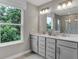 Bathroom featuring double vanity with stone countertop, neutral color palette, and a picturesque window view at 5314 Pelion Pl, McCordsville, IN 46055