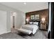 Comfortable bedroom featuring a wood accent wall, plush bedding, and bright natural light from a window at 5314 Pelion Pl, McCordsville, IN 46055