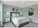 Bedroom with turquoise walls, bright white trim, and a bed with decorative pillows and throw, and a bedside table with lamps at 5314 Pelion Pl, McCordsville, IN 46055