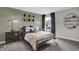 This bedroom features neutral color palette, carpeted floor, large window, stylish decor, and sports-themed accents at 5314 Pelion Pl, McCordsville, IN 46055