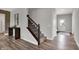 Welcoming foyer with wood floors and a staircase, providing an inviting entrance and access to the upper level at 5314 Pelion Pl, McCordsville, IN 46055