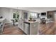Spacious open-concept kitchen with island, stainless steel dishwasher, and views into the living room at 5314 Pelion Pl, McCordsville, IN 46055