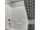 Clean white shower tub with gray patterned shower curtain is a relaxing oasis at 5314 Pelion Pl, McCordsville, IN 46055