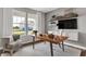 Well-lit home office with a view, featuring a comfortable chair, desk, and built-in shelving for functional decor at 5314 Pelion Pl, McCordsville, IN 46055