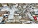 Residential street with tree-lined sidewalks, homes with driveways, and manicured lawns covered in snow at 5614 Personality Ct, Indianapolis, IN 46237