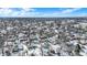 A wide aerial view of a sprawling neighborhood, highlighting its dense housing and established trees against a bright sky at 5614 Personality Ct, Indianapolis, IN 46237