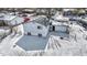 An elevated view showcases a snow-covered backyard with a well-maintained home and convenient street access at 5614 Personality Ct, Indianapolis, IN 46237