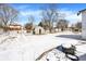 A large backyard featuring a shed and a fire pit, covered in snow at 5614 Personality Ct, Indianapolis, IN 46237
