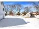 Large backyard featuring a shed with a snow covered yard and bare trees at 5614 Personality Ct, Indianapolis, IN 46237