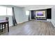 Basement is enhanced with modern floors, and a media center featuring built-in shelving and a large screen TV at 5614 Personality Ct, Indianapolis, IN 46237