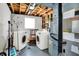 Basement laundry area features newer appliances, painted walls, and exposed unfinished ceiling at 5614 Personality Ct, Indianapolis, IN 46237