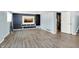 The basement is finished with durable vinyl flooring and an entertainment area including built in shelves and modern tv at 5614 Personality Ct, Indianapolis, IN 46237