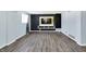 Spacious finished basement with vinyl flooring and media center with a TV, built-in shelving, and storage at 5614 Personality Ct, Indianapolis, IN 46237