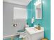 Bathroom featuring a white vanity, a blue accent wall, and blue toilet cover and rug at 5614 Personality Ct, Indianapolis, IN 46237