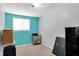 Comfortable bedroom features a window, turquoise accent wall, and convenient closet-cube storage at 5614 Personality Ct, Indianapolis, IN 46237