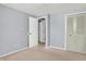 Cozy bedroom featuring neutral walls and carpet, closet, and doorway to the hall at 5614 Personality Ct, Indianapolis, IN 46237