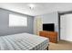 This bedroom has a neutral palette, a tv, blinds, and a closet for storage at 5614 Personality Ct, Indianapolis, IN 46237