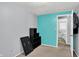Bright bedroom features an turquoise accent wall, storage cubes, and door to the bathroom at 5614 Personality Ct, Indianapolis, IN 46237